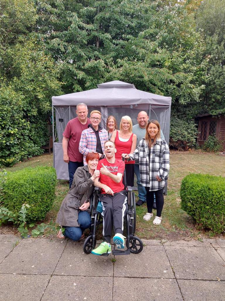 Patient with his family, staff and Penny Bailey.JPG