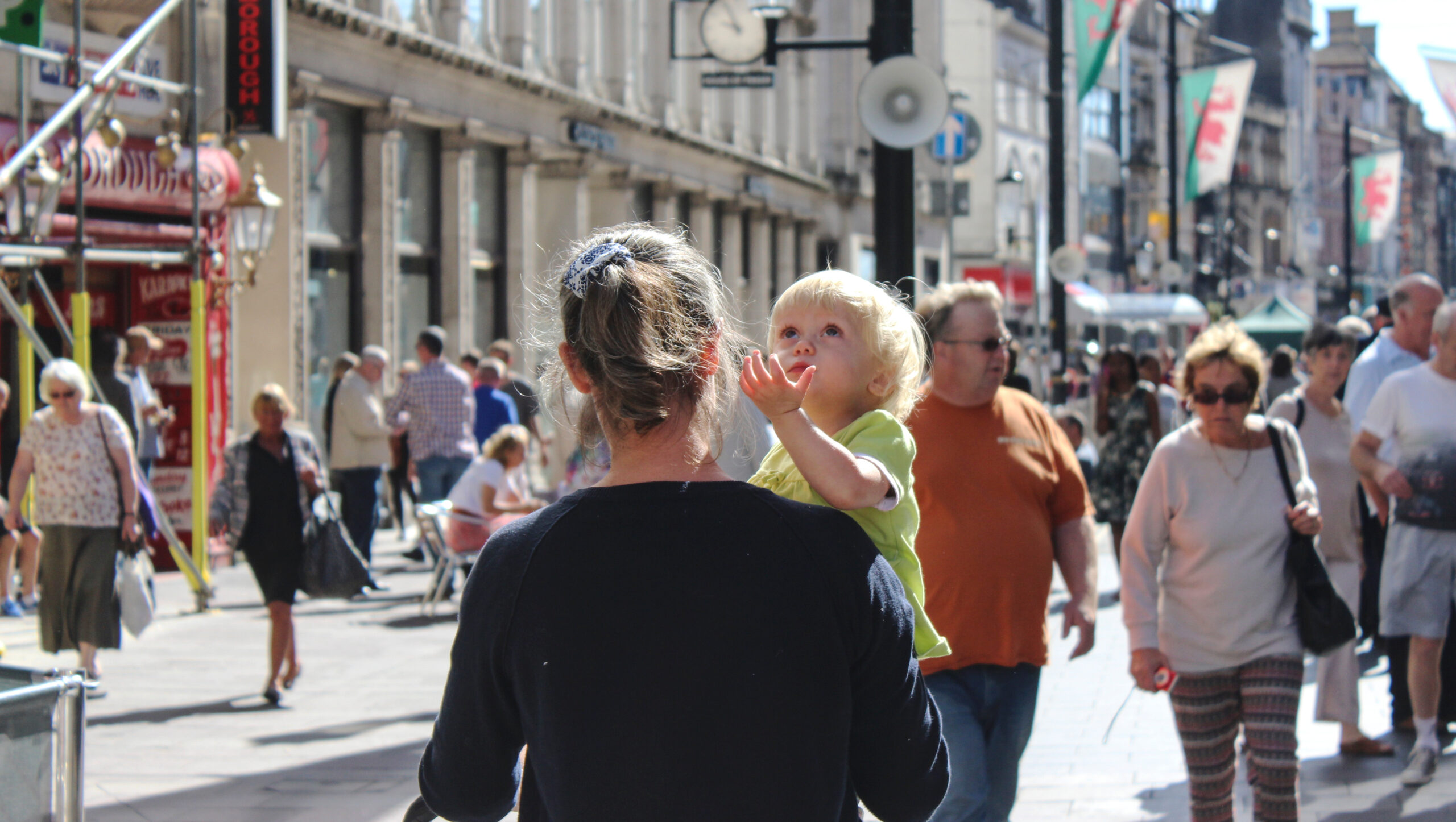 Blonde-child-in-mothers-arms-is-looking-up-the-sky-Cardiff-scaled (1).jpg
